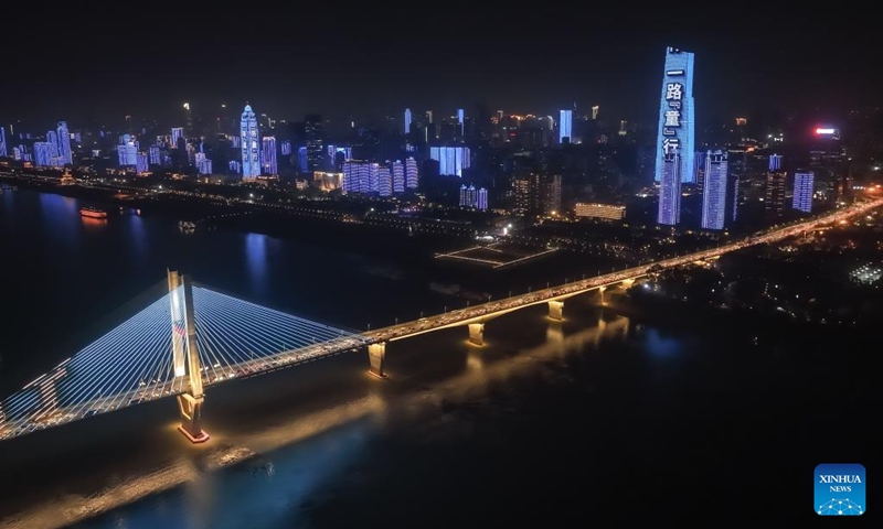 This aerial photo taken on Nov. 20, 2023 shows the Second Yangtze River Bridge and surroundings being lit up to celebrate World Children's Day in Wuhan, capital of central China's Hubei Province.(Photo: Xinhua)