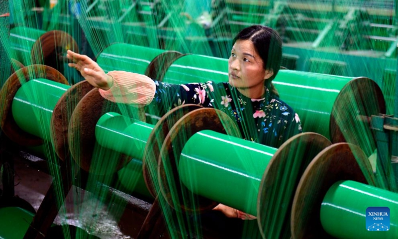 A woman works at a workshop of an enterprise in Jianglou Town of Huimin County, east China's Shandong Province, Nov. 22, 2023. Huimin has more than 1,300 enterprises producing net and rope products, which are widely used in construction, sports and other industries. From January to October this year, this industry in Huimin has achieved an output value of over 21.7 billion yuan (about 3.03 billion U.S. dollars).(Photo: Xinhua)