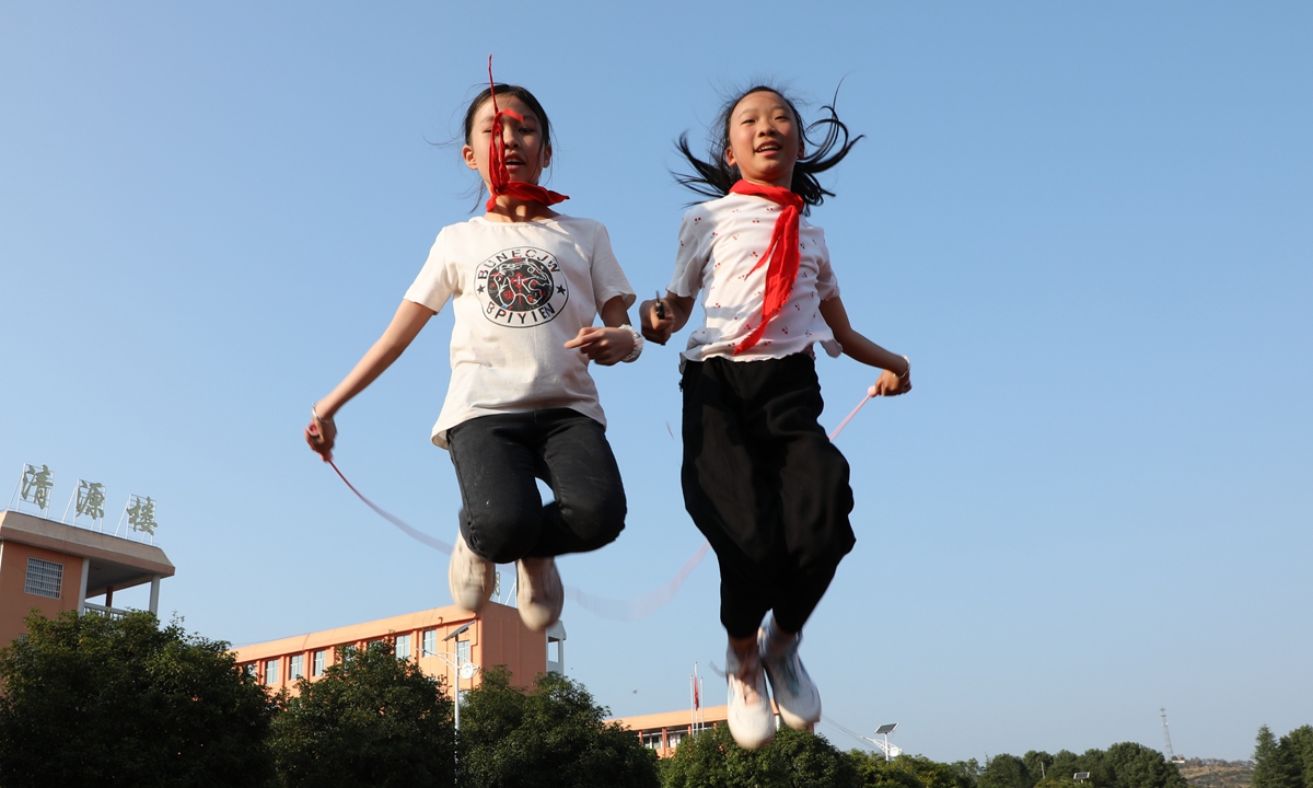 Two girls take part in a jump rope competition in Baojing county, Central China's Hunan Province, on November 23, 2023. Students participated in various competitions and enjoyed the fun of sports at the sports meeting in a school. Photo: VCG