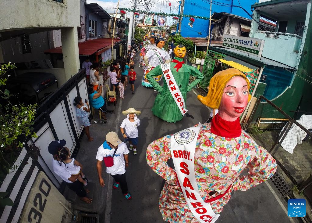 Large papier-mache puppets dressed in colorful costumes are paraded along a street during the Higantes (giants) Festival in Rizal Province, the Philippines on Nov. 22, 2023.(Photo: Xinhua)