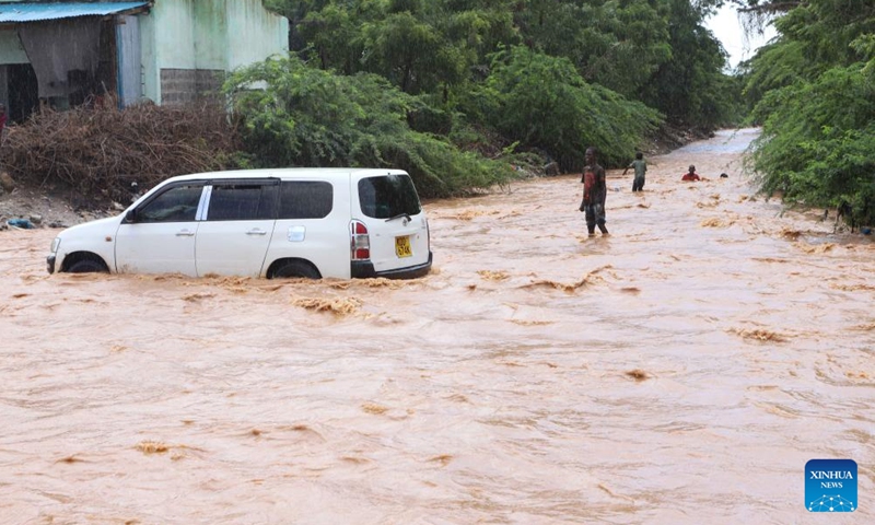 A car crosses a flooded road following heavy downpour in Garissa County, northern Kenya on Nov. 22, 2023. According to the Kenya Red Cross Society, at least 71 people have died, over 200 injured and more than 150,000 others displaced across the country as heavy rains continue to cause havoc.(Photo: Xinhua)