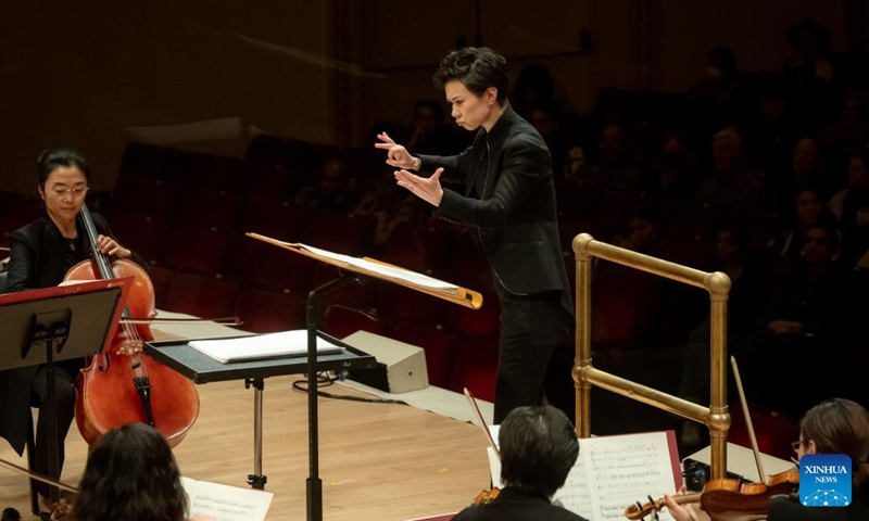 Lin Chen, a conductor from the Central Conservatory of Music of Beijing, China, conducts the performance at Carnegie Hall in New York, the United States on Nov. 24, 2023. Artists from the leading Chinese symphony orchestra returned here on Friday night after a COVID-induced hiatus and won the hearts of over a thousand audience members with their world premiere compositions. (Photo: Xinhua)