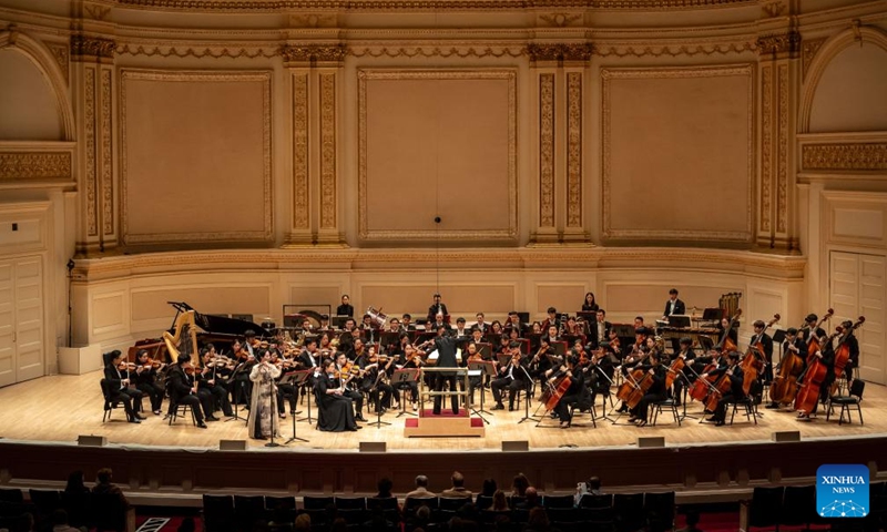 Artists from the Central Conservatory of Music Symphony Orchestra of Beijing, China perform at Carnegie Hall in New York, the United States on Nov. 24, 2023. Artists from the leading Chinese symphony orchestra returned here on Friday night after a COVID-induced hiatus and won the hearts of over a thousand audience members with their world premiere compositions.(Photo: Xinhua)