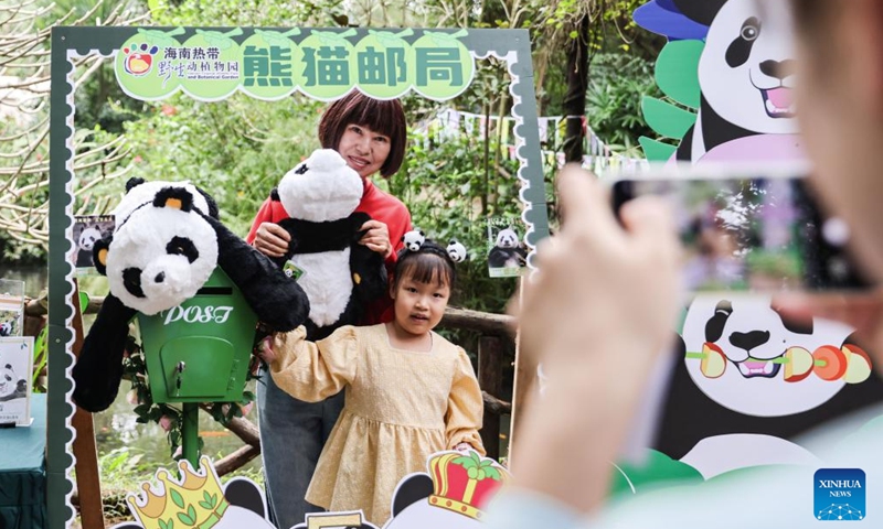 Visitors pose for photos at the Hainan Tropical Wildlife Park and Botanical Garden in Haikou, south China's Hainan Province, Nov. 25, 2023. Giant pandas Gonggong and Shunshun have lived in Hainan for five years since they made their public debut at the Hainan Tropical Wildlife Park and Botanical Garden in 2018. A celebration ceremony was held here on Saturday, attracting lots of visitors. (Photo: Xinhua)