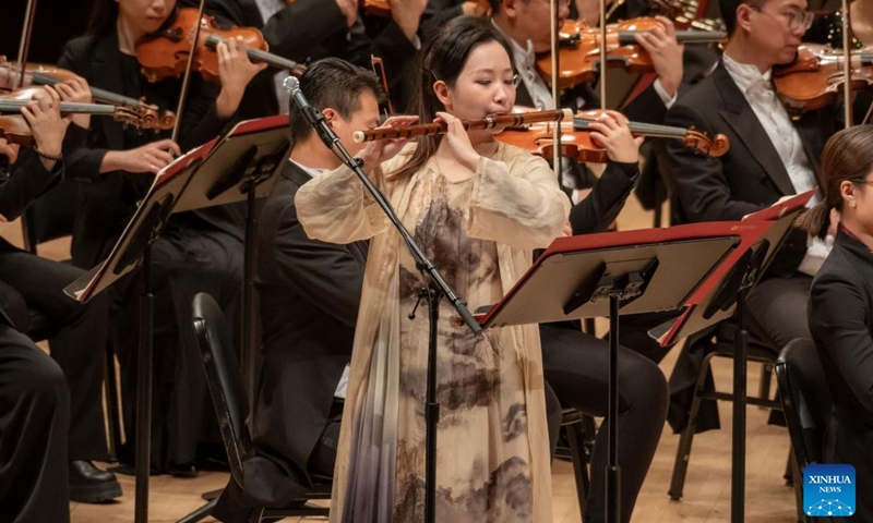 Fan Linfeng, a bamboo flute player from the Central Conservatory of Music of Beijing, China, performs at Carnegie Hall in New York, the United States on Nov. 24, 2023. Artists from the leading Chinese symphony orchestra returned here on Friday night after a COVID-induced hiatus and won the hearts of over a thousand audience members with their world premiere compositions. (Photo: Xinhua)