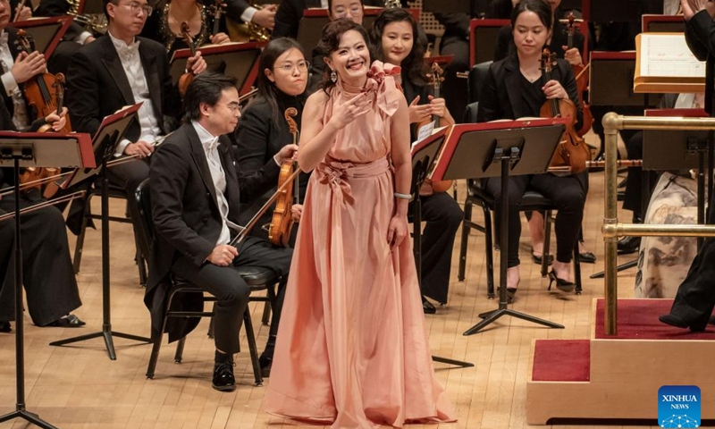 Song Yuanming, a soprano from the Central Conservatory of Music of Beijing, China, performs at Carnegie Hall in New York, the United States on Nov. 24, 2023. Artists from the leading Chinese symphony orchestra returned here on Friday night after a COVID-induced hiatus and won the hearts of over a thousand audience members with their world premiere compositions. (Photo: Xinhua)