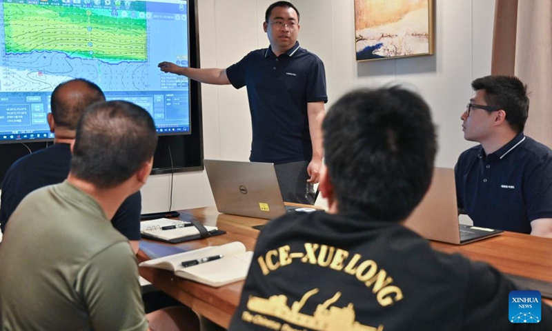 Li Jingshi, a meteorological expert, illustrates weather conditions under westerlies aboard China's research icebreaker Xuelong 2, on Nov. 23, 2023. Currently on an Antarctic expedition, the icebreaker, otherwise known as Snow Dragon 2, is ploughing through the belt of prevailing westerlies, nicknamed the rolling forties, with its companion cargo vessel Tian Hui. (Photo: Xinhua)