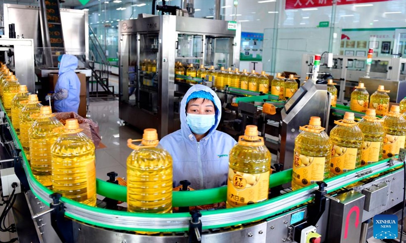 Employees work at a production line of a cooking oil plant in Boxing County, east China's Shandong Province, Nov. 26, 2023. (Photo: Xinhua)