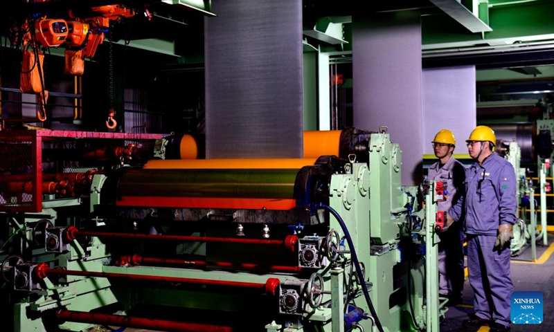 Employees work at a galvanized sheet production line in Boxing County, east China's Shandong Province, Nov. 26, 2023. (Photo: Xinhua)