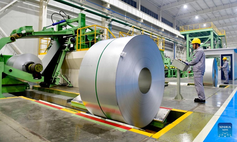 Employees work at a galvanized sheet production line in Boxing County, east China's Shandong Province, Nov. 26, 2023. (Photo: Xinhua)