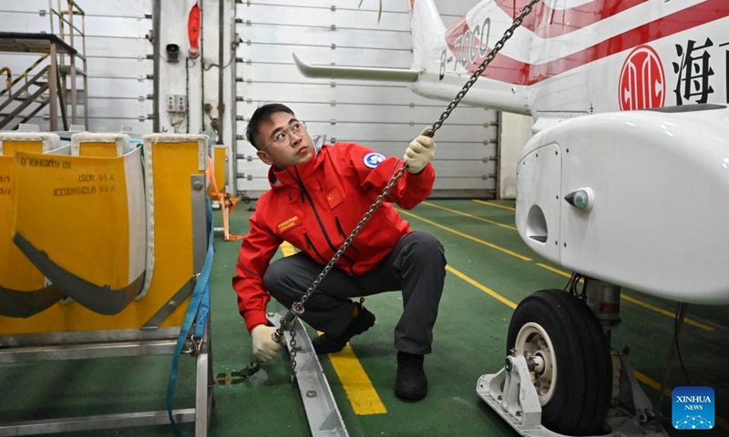 Wang Fa, a machinist, checks and tightens constraining gears aboard China's research icebreaker Xuelong 2, on Nov. 26, 2023. Currently on an Antarctic expedition, the icebreaker, otherwise known as Snow Dragon 2, is ploughing through the belt of prevailing westerlies, nicknamed the rolling forties, with its companion cargo vessel Tian Hui. (Photo: Xinhua)