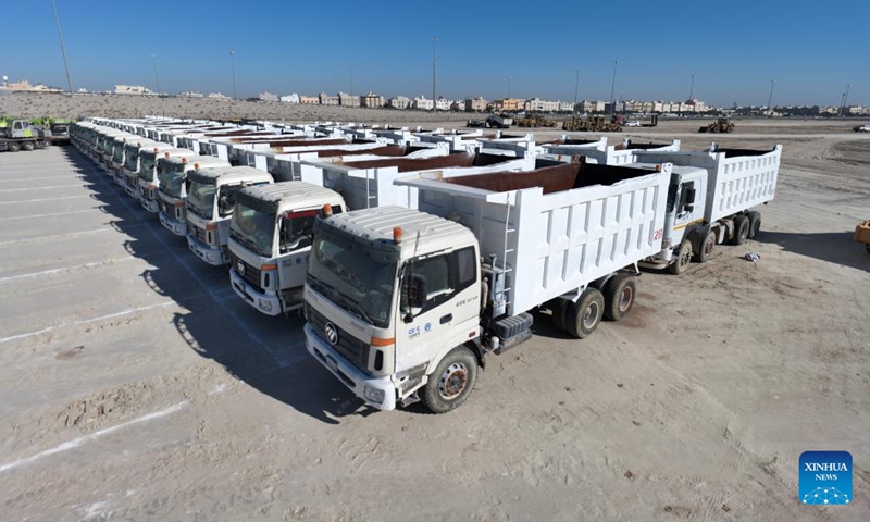 This aerial photo taken on Dec. 4, 2023 shows trucks at the construction site of the South Saad Al-Abdullah City Housing Project in Jahra Governorate, Kuwait. Kuwait's South Saad Al-Abdullah City housing project started construction on Monday. China Gezhouba Group Co., Ltd (CGGC) undertakes the construction of the project, which is located in Jahra Governorate, about 25 km west of Kuwait City.(Photo: Xinhua)