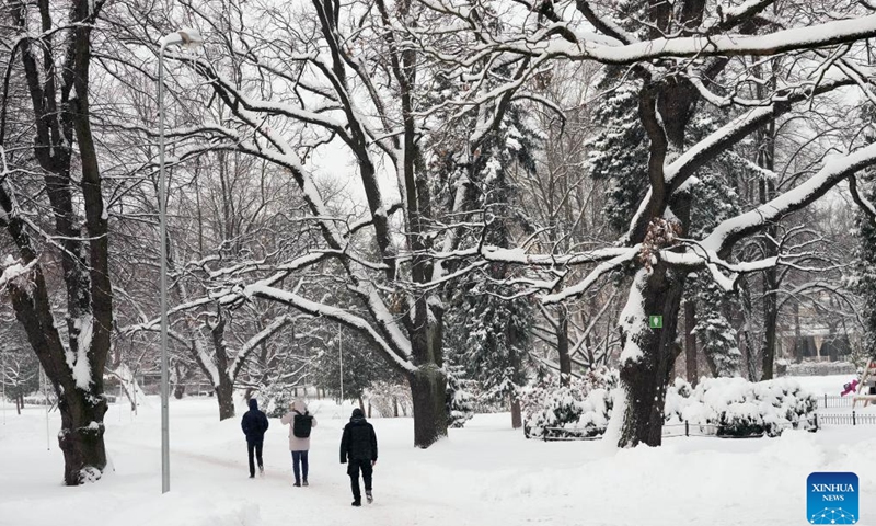 People walk in the snow in Riga, Latvia, Nov. 30, 2023.(Photo: Xinhua)