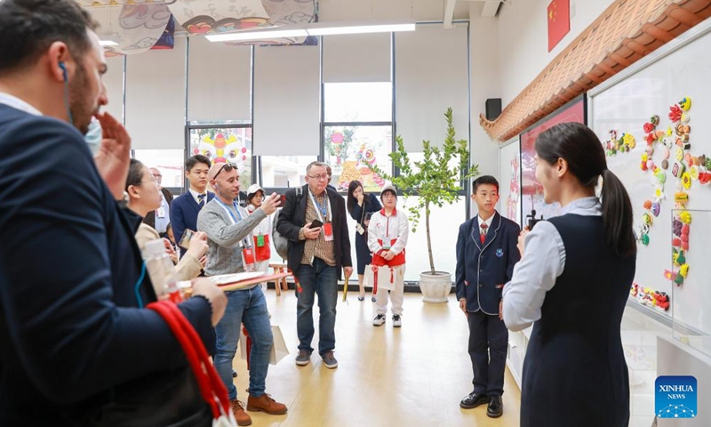 Delegates attending the 5th World Media Summit (WMS) visit Guangzhou Foreign Language School in Guangzhou, south China's Guangdong Province, Dec. 2, 2023. The fifth summit hosted by Xinhua News Agency has started from Dec. 2, in China's Guangzhou city of Guangdong Province and Kunming city of Yunnan Province. (Photo: Xinhua)