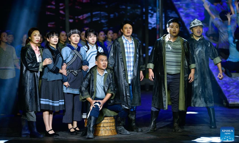 Artists perform in an opera based on the story of Huang Wenxiu, a village official who died in 2019 on the frontline of China's war against poverty, at Guiyang Grand Theatre in Guiyang, southwest China's Guizhou Province, Nov. 30, 2023. (Photo: Xinhua)