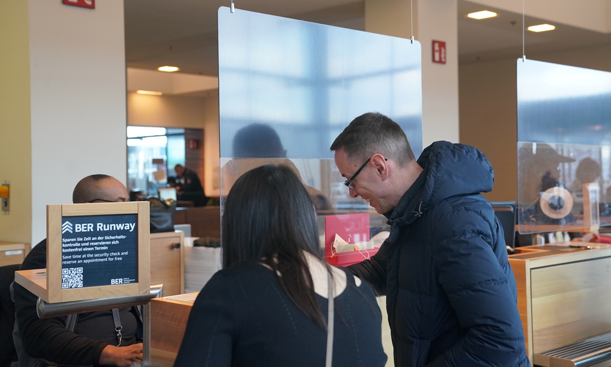 Passengers flying to China check in at the counter at Berlin Brandenburg Airport in Germany on December 1, 2023. Photo: VCG