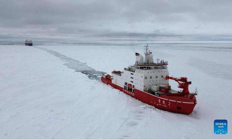 This aerial photo taken on Dec. 3, 2023 shows China's research icebreaker Xuelong 2 (near) breaking ice and ploughing a waterway for cargo vessel Tian Hui. China's research icebreaker Xuelong 2 and its companion cargo vessel Tian Hui are now sailing through ice floes. (Photo: Xinhua)