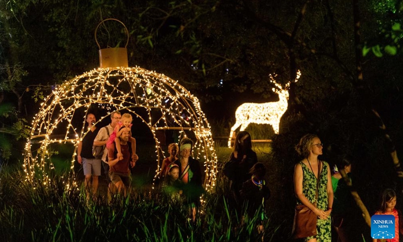 People visit Johannesburg Zoo during the Festival of Lights in Johannesburg, South Africa, Dec. 2, 2023. Featuring an enchanting collection of illuminated life-size animal characters, the event attracted people to visit the zoo at night. (Photo: Xinhua)