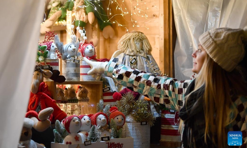 A woman visits the lakeside Christmas market in Montreux, Switzerland, Dec. 2, 2023. The lakeside Christmas market in Montreux is one of the most famous of its kind in the country. (Photo: Xinhua)