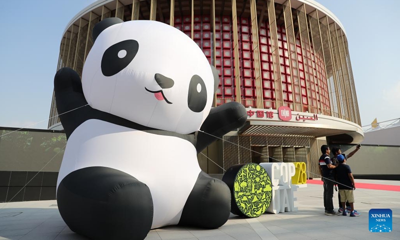 Visitors pose for photos in front of the China's pavilion at the Green Zone of the 28th session of the Conference of the Parties to the United Nations Framework Convention on Climate Change (COP28), in Dubai, the United Arab Emirates, Dec. 3, 2023. Green Zone of COP28 opens to the public at the Expo City of Dubai on Sunday. (Photo: Xinhua)