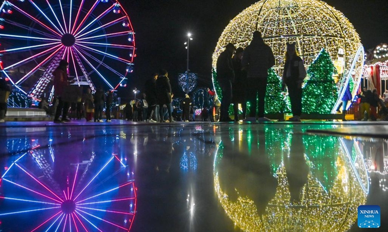 People visit a Christmas fairyland near the Triton Fountain in Valletta, Malta, Dec. 9, 2023. The fairyland decorated with Christmas lights was opened on Dec. 8, 2023 and will stay open until Jan. 7, 2024. (Photo: Xinhua)