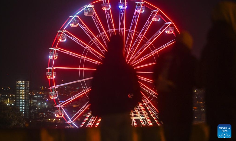 A Ferris wheel is seen at a Christmas fairyland near the Triton Fountain in Valletta, Malta, Dec. 9, 2023. The fairyland decorated with Christmas lights was opened on Dec. 8, 2023 and will stay open until Jan. 7, 2024. (Photo: Xinhua)