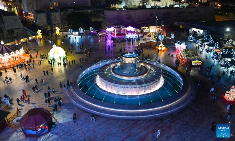 People visit a Christmas fairyland near the Triton Fountain in Valletta, Malta, Dec. 9, 2023. The fairyland decorated with Christmas lights was opened on Dec. 8, 2023 and will stay open until Jan. 7, 2024. (Photo: Xinhua)