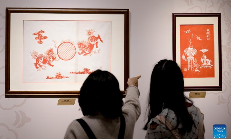 Visitors look at artwork during an intangible cultural heritage exhibition on the Maritime Silk Road in Quanzhou, southeast China's Fujian Province, Dec. 9, 2023. The city of Quanzhou is widely believed to be the starting point of the ancient Maritime Silk Road. (Photo: Xinhua)