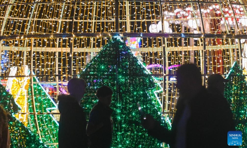 People visit a Christmas fairyland near the Triton Fountain in Valletta, Malta, Dec. 9, 2023. The fairyland decorated with Christmas lights was opened on Dec. 8, 2023 and will stay open until Jan. 7, 2024. (Photo: Xinhua)