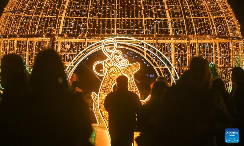 People visit a Christmas fairyland near the Triton Fountain in Valletta, Malta, Dec. 9, 2023. The fairyland decorated with Christmas lights was opened on Dec. 8, 2023 and will stay open until Jan. 7, 2024. (Photo: Xinhua)