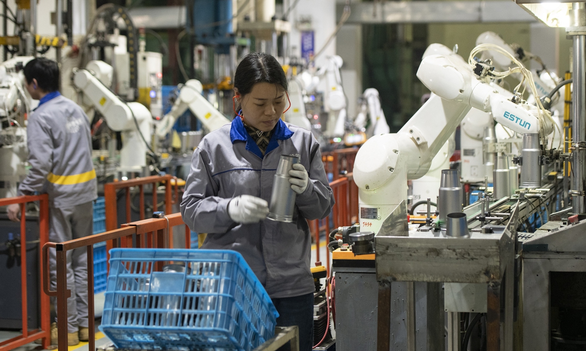 Workers ramp up production of vacuum bottles at a plant in Jinhua, East China's Zhejiang Province on December 13, 2023. The arrival of a cold wave across much of northern China has spurred the sales of heaters, warm clothing and hot-water bottles. Photo: VCG