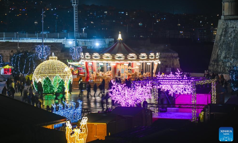 People visit a Christmas fairyland near the Triton Fountain in Valletta, Malta, Dec. 9, 2023. The fairyland decorated with Christmas lights was opened on Dec. 8, 2023 and will stay open until Jan. 7, 2024. (Photo: Xinhua)