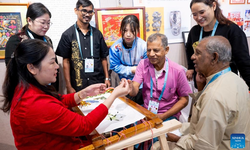 Sri lankan visitors learn about traditional techniques of Zhangzhou embroidery, which is recognized as a provincial intangible cultural heritage of Fujian, during an intangible cultural heritage exhibition on the Maritime Silk Road in Quanzhou, southeast China's Fujian Province, Dec. 9, 2023. The city of Quanzhou is widely believed to be the starting point of the ancient Maritime Silk Road. (Photo: Xinhua)