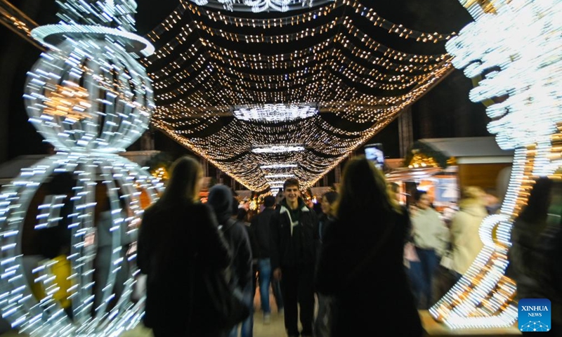 People visit a Christmas fairyland near the Triton Fountain in Valletta, Malta, Dec. 9, 2023. The fairyland decorated with Christmas lights was opened on Dec. 8, 2023 and will stay open until Jan. 7, 2024. (Photo: Xinhua)