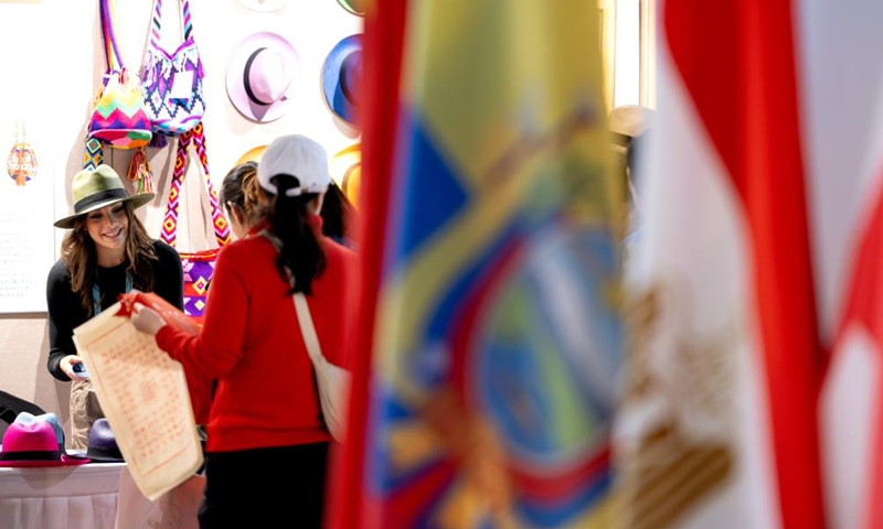 Visitors select products from Ecuador during an intangible cultural heritage exhibition on the Maritime Silk Road in Quanzhou, southeast China's Fujian Province, Dec. 9, 2023. The city of Quanzhou is widely believed to be the starting point of the ancient Maritime Silk Road. (Photo: Xinhua)