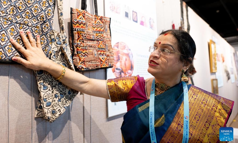 An Indian artist displays handmade bags during an intangible cultural heritage exhibition on the Maritime Silk Road in Quanzhou, southeast China's Fujian Province, Dec. 9, 2023. The city of Quanzhou is widely believed to be the starting point of the ancient Maritime Silk Road. (Photo: Xinhua)