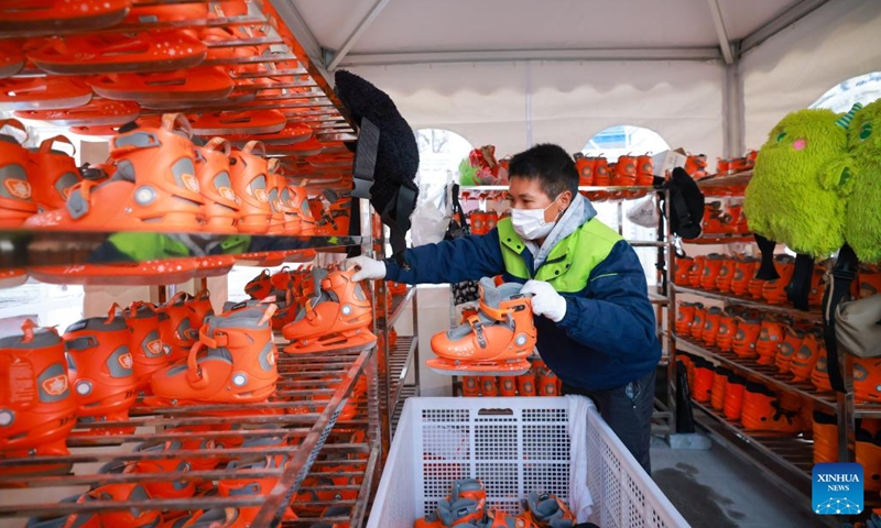 A staff member puts skates in place at an ice rink in a public square of the Italian Style Area in Tianjin, north China, Dec. 9, 2023. (Photo: Xinhua)