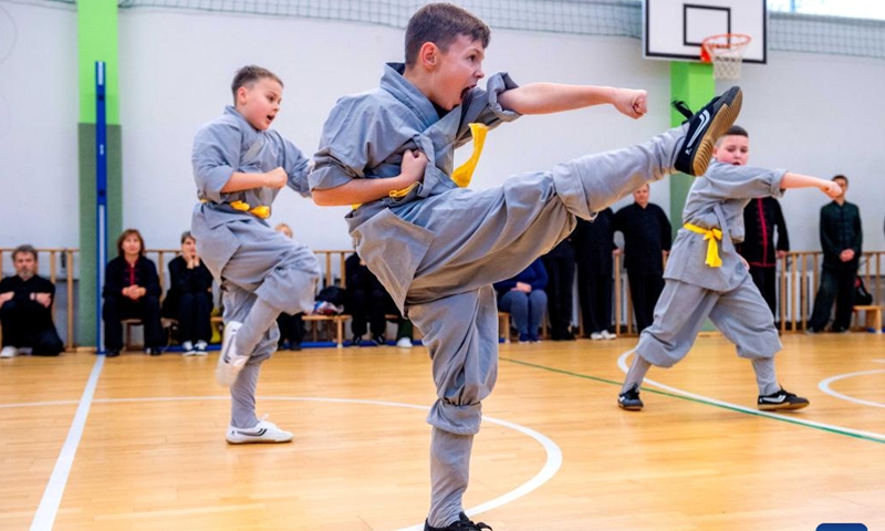 Participants perform at the Chinese Wushu (Kung Fu) and Tai Chi Performance Competition held by Lithuanian Wushu Federation in Vilnius, Lithuania, Dec. 9, 2023. (Photo: Xinhua)