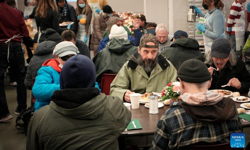 People enjoy meals during the annual Christmas dinner at Union Gospel Mission (UGM) in Vancouver, British Columbia, Canada, on Dec. 9, 2023. (Photo: Xinhua)