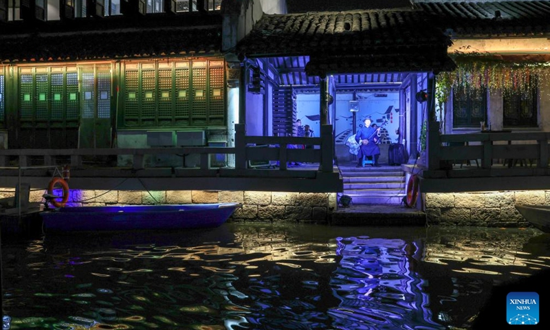 Artists perform Pingtan, a form of ballad singing in local dialect with Chinese instruments, at a historical and cultural district along the Grand Canal in Wuxi, east China's Jiangsu Province, Dec. 7, 2023. (Photo: Xinhua)