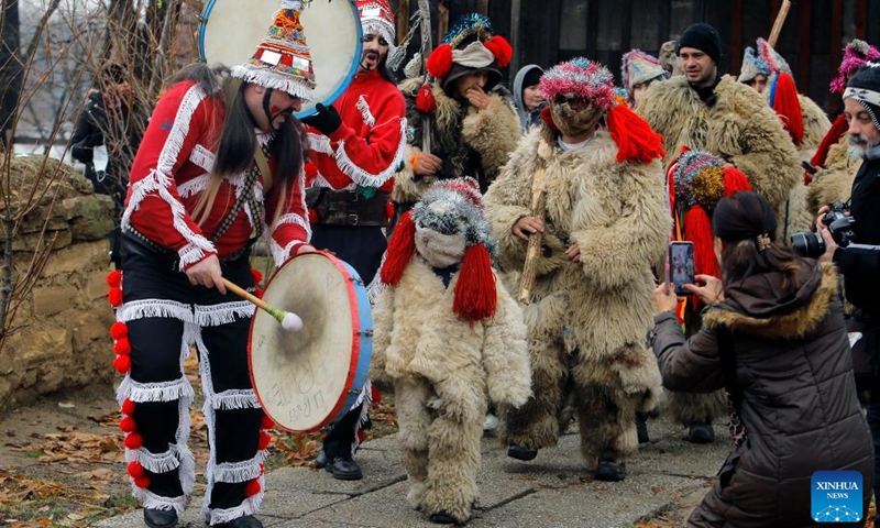 Members of a traditional song and dance band attend a parade during the White Flowers festival of traditions and customs at the Village Museum in Bucharest, capital of Romania, on Dec. 10, 2023. The festival is organized annually with the aim of presenting Christmas and New Year traditions to the public. (Photo: Xinhua)