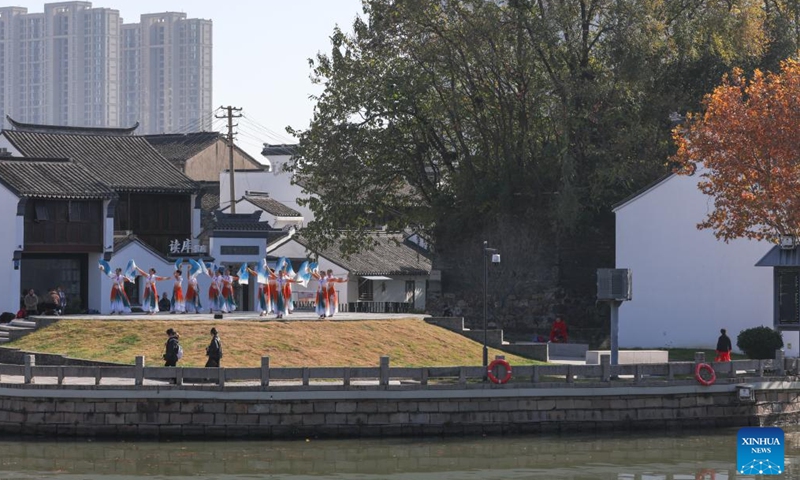 People dance at a historical and cultural district along the Grand Canal in Wuxi, east China's Jiangsu Province, Dec. 8, 2023. (Photo: Xinhua)