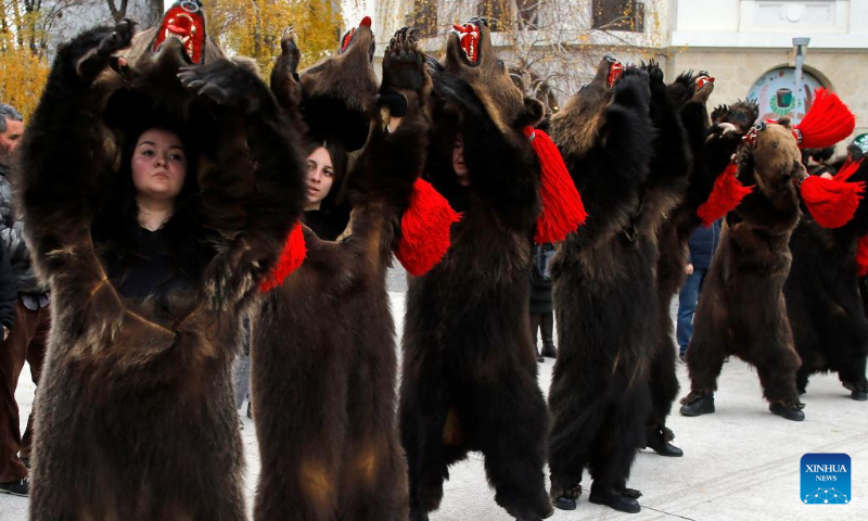 Members of a traditional song and dance band perform bear dance during the 