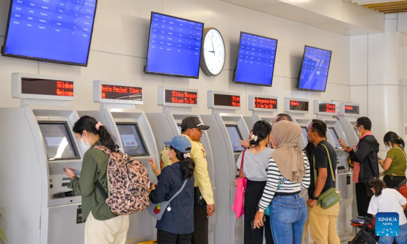 Passengers get tickets on ticketing machines at Halim Station in Jakarta, Indonesia, Dec. 17, 2023. According to PT Kereta Cepat Indonesia-China (KCIC), a joint venture consortium between Indonesian and Chinese state-owned firms that constructs and runs the Jakarta-Bandung high-speed railway (HSR), the HSR has delivered more than 700,000 passengers since it was officially put into commercial operation on Oct. 17. (Xinhua/Xu Qin)