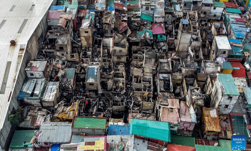 This aerial photo shows the site after a fire at a slum area in Manila, the Philippines on Dec. 12, 2023. The pre-dawn fire that erupted Tuesday left 240 families homeless, the Philippine Bureau of Fire Protection said.(Photo: Xinhua)