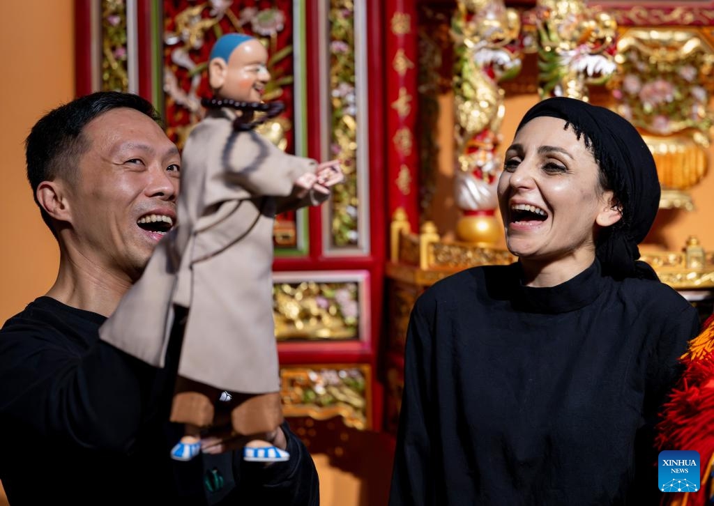 Iranian puppeteer Fahimeh Barotchi (R) reacts as Chen Daigong, puppeteer and inheritor of a local Chinese puppet performing art, demonstrates at a puppet art preservation center in Jinjiang of Quanzhou City, southeast China's Fujian Province, Dec. 11, 2023. Puppet artists from 12 countries are invited to Quanzhou, a city widely believed to be the starting point of the ancient Maritime Silk Road, to give puppet performances and communicate with local puppet artists.(Photo: Xinhua)