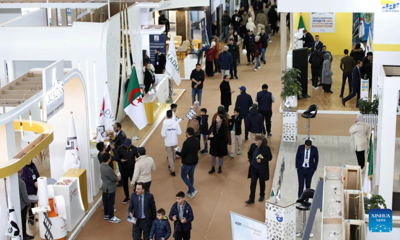 People attend the Algerian Production Fair in Algiers, Algeria, on Dec. 16, 2023. The fair is held here from Dec. 14 to Dec. 23. (Xinhua)