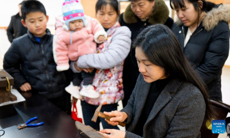 An intangible cultural heritage inheritor demonstrates traditional ceramic mending technique at the Xiaojiashan aesthetic education research base in Xiaojiashan Village of Sanming City, southeast China's Fujian Province, Dec. 16, 2023. (Xinhua/Wei Peiquan)