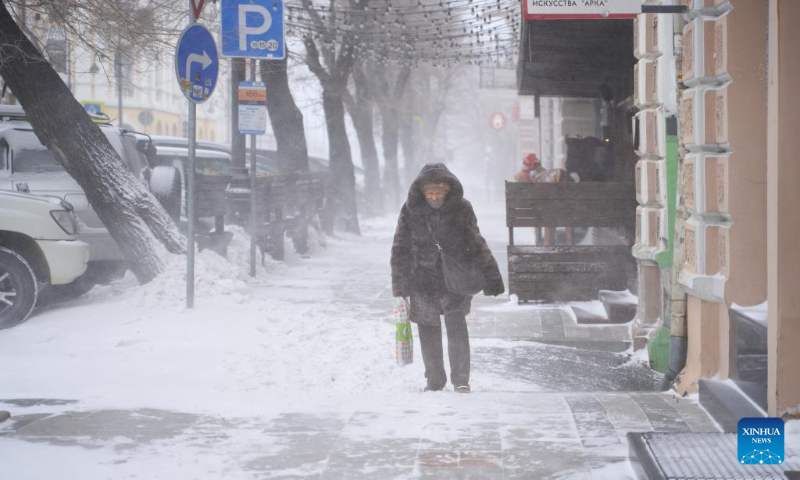 A person walks against the blizzard in Vladivostok, Russia, Dec. 16, 2023. (Photo by Guo Feizhou/Xinhua)