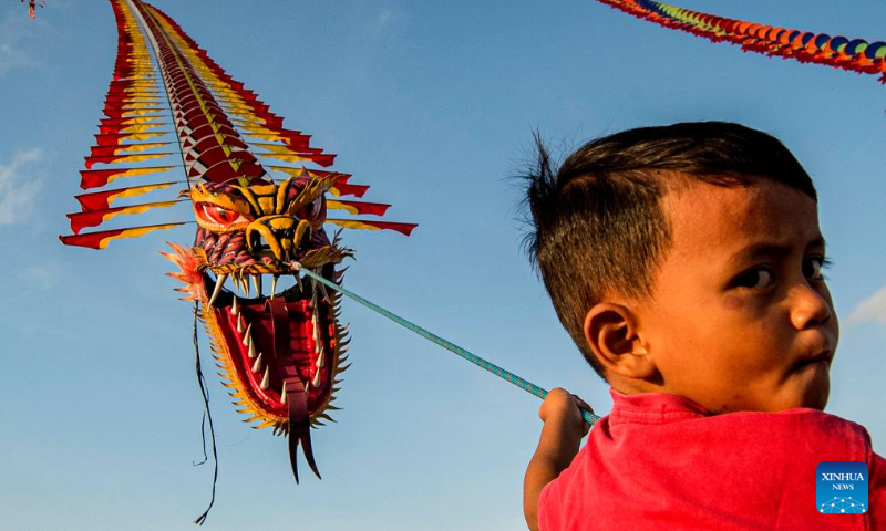 A boy flies a dragon kite at Parangkusumo beach in Bantul district, Yogyakarta, Indonesia, on Dec. 17, 2023. (Photo by Agung Supriyanto/Xinhua)